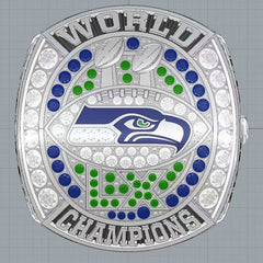 Silver championship ring with Seahawks logo and 'World Champions' text on a gray background